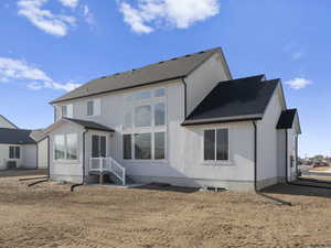 Rear view of house featuring central air condition unit