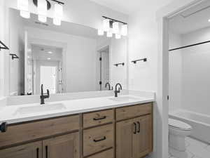 Full bathroom featuring tile patterned floors, vanity, toilet, and bathtub / shower combination