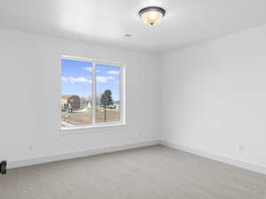 Unfurnished room with carpet flooring and a textured ceiling