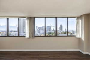 Empty room featuring dark hardwood / wood-style floors, a mountain view, and a textured ceiling