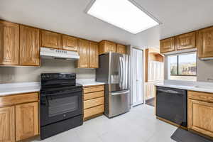 Kitchen featuring black appliances and sink