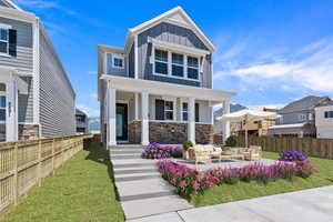 Craftsman-style home featuring an outdoor living space and a front lawn