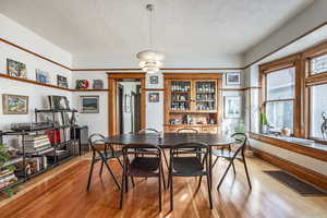 Dining room featuring a textured ceiling and light wood-type flooring