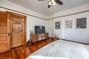 Bedroom featuring hardwood / wood-style floors and ceiling fan