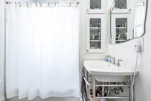 Bathroom featuring shower / tub combo with curtain