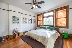 Bedroom with hardwood / wood-style floors and ceiling fan