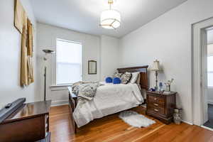 Bedroom with hardwood / wood-style floors