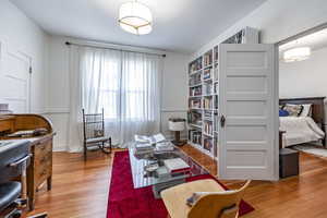 Sitting room with wood-type flooring