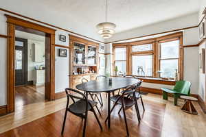 Dining room featuring a textured ceiling, light wood-type flooring, and plenty of natural light