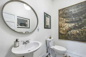 Bathroom with tile patterned floors, toilet, and sink