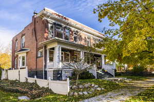 View of front of home with a balcony and covered porch