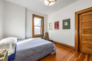 Bedroom with hardwood / wood-style flooring