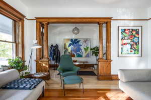 Sitting room featuring hardwood / wood-style floors and decorative columns