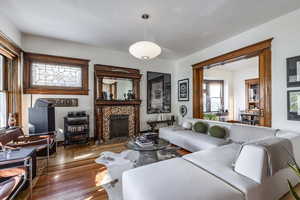 Living room with a fireplace and hardwood / wood-style floors