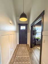 Entryway featuring office and vaulted cielings.