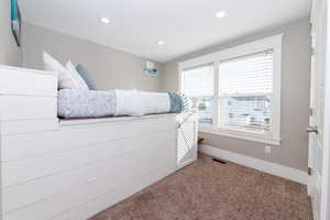 Bedroom featuring light colored carpet