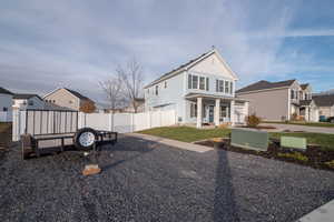 View of front of house featuring a front lawn and a porch