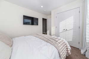 Carpeted bedroom featuring a closet