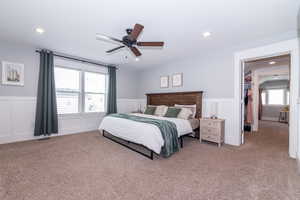 Bedroom featuring ceiling fan and light carpet