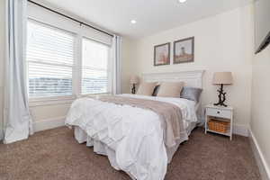 Bedroom with dark carpet