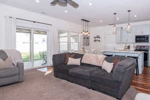 Living room with hardwood / wood-style floors and ceiling fan