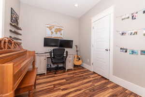 Office space with built in desk and dark hardwood / wood-style floors