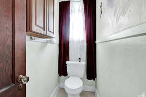 Bathroom with tile patterned flooring and toilet