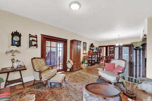 Living room featuring light hardwood / wood-style flooring and a notable chandelier