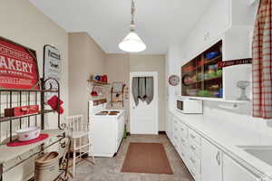 Kitchen with white cabinetry, tile counters, hanging light fixtures, white appliances, and light tile patterned floors