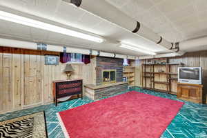 Interior space featuring wood walls and a fireplace