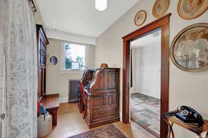 Interior space with radiator and light hardwood / wood-style flooring