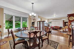 Dining room featuring light wood-type flooring and a chandelier