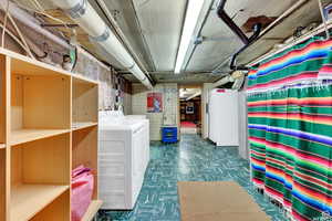 Basement featuring washing machine and clothes dryer