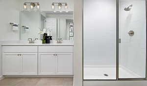 Bathroom featuring vanity, tile patterned floors, and a shower with doorUnder Construction. Pictures of a model for example only. Colors and other features may vary from picture.