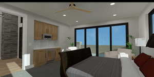 Interior space with wine cooler, ceiling fan, and light hardwood / wood-style floors