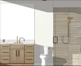 Bathroom featuring vanity, toilet, and a shower with shower door