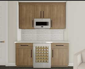 Kitchen featuring tasteful backsplash and light brown cabinetry