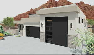 View of front of house with a mountain view and a garage