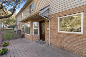 Wooden deck featuring cooling unit