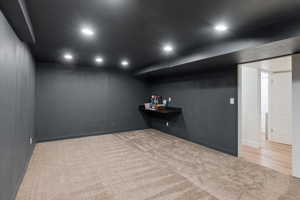 Basement with light carpet