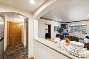 Interior space featuring stainless steel refrigerator and ornamental molding