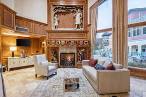 Living room featuring wood walls and a towering ceiling