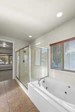 Bathroom featuring tile patterned floors and independent shower and bath