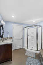 Bathroom featuring vanity and an enclosed shower