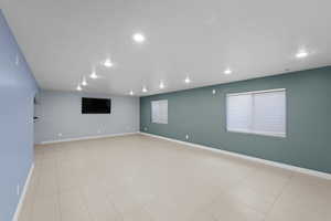 Empty room with plenty of natural light and a textured ceiling