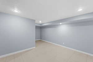 Basement featuring a textured ceiling