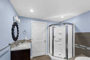 Bathroom with vanity, tile patterned floors, and a shower with shower door