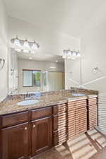 Bathroom with tile patterned floors, vanity, and walk in shower