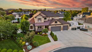 View of front of house featuring a mountain view and a yard