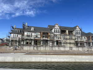 View of property with a water view